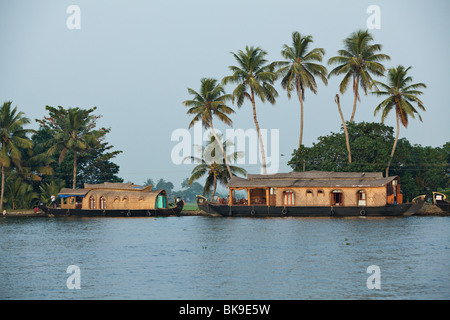 Kettuvallams, traditional style houseboats, cruise the backwater canals of Kerala, India. Stock Photo