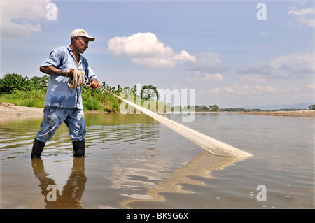 Fisherman tossing a net into the Rio Magdalena River, La Dorada, Caldas, Colombia, South America Stock Photo