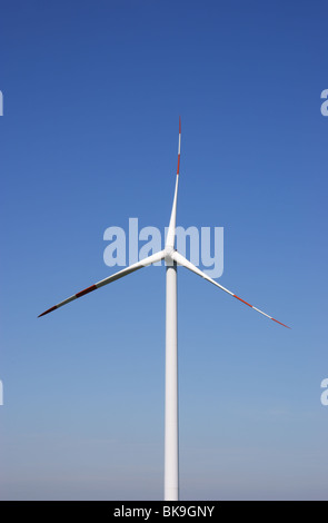 Wind energy turbine power station against blue sky. Lot of copy space. Stock Photo