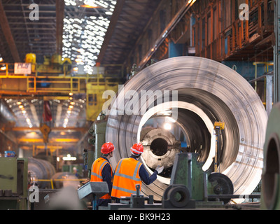 Engineers In Steel Factory With Lathe