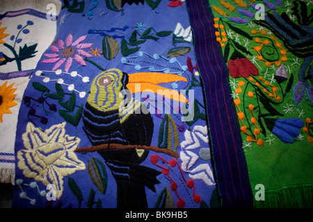 An embroidered blanket decorated with a toucan hangs for sale in a shop in Zinacantan, Chiapas, Mexico, February 28, 2010. Stock Photo