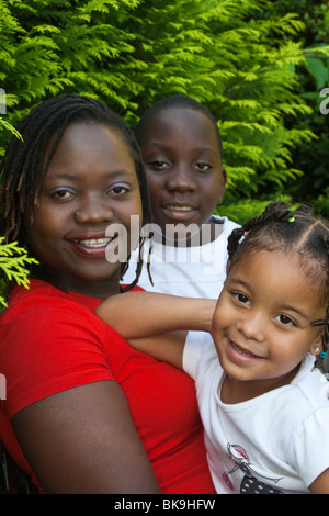 A happy relaxed family portrait in their garden Stock Photo