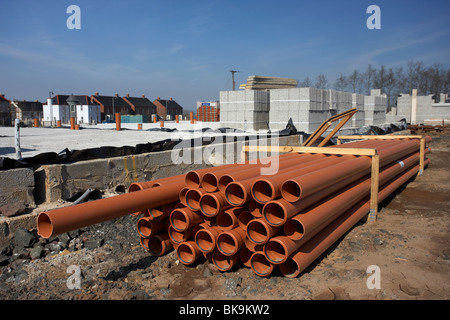 pile of underground sewage and water pipes on construction building site in northern ireland uk Stock Photo