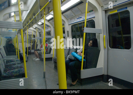 London underground tired person, woman sleep sleeping asleep on tube train at night. London 2010 2010s UK HOMER SYKES Stock Photo