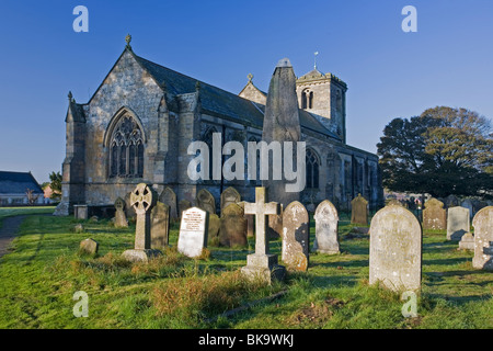 All Saints Parish Church and Ancient Monolith in The Yorkshire Wolds village of East Rudston, East Yorkshire, UK Stock Photo