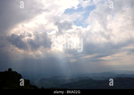 Rays of light filtering through the clouds before the storm in Asturias, Spain. Stock Photo