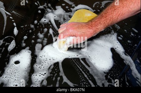 Man giving vehicle a hand car wash, Farnham, Surrey, UK. Stock Photo