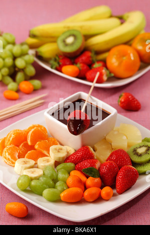 Fruit skewers with chocolate. Recipe available. Stock Photo