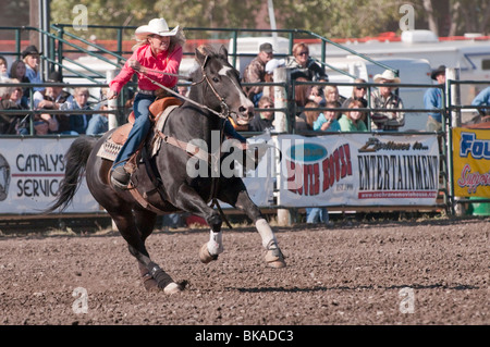 Cowgirl riding fast during barrel racing, Cochrane Rodeo, Cochrane, Alberta, Canada Stock Photo