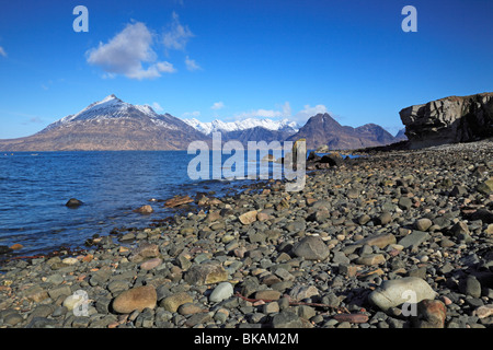 Isle of Skye - View from Elgol to  snow capped Cuillin mountains across Loch Scavaig on a beautiful Spring day Stock Photo