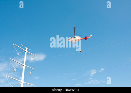 String Helicopter a helicopter is used to string a cable during construction of a new ...