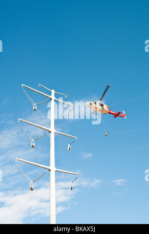 String Helicopter a helicopter is used to string a cable during construction of a new ...