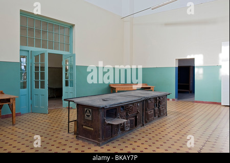 Old Wood Fired Iron Stove in the Kitchens of the Theatre & Ballroom, Kolmanskop Ghost Town near Luderitz, Namibia Stock Photo