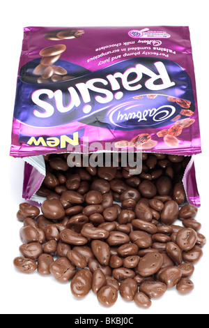 Bag of Cadbury's milk chocolate covered raisins spilling onto a white surface Stock Photo