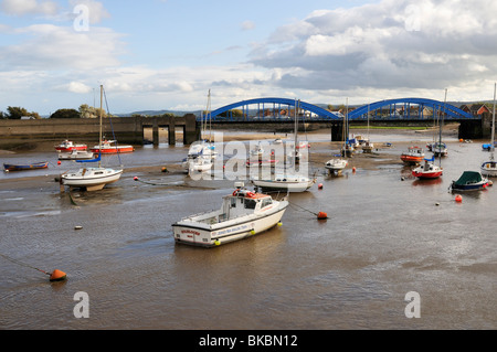 Boats moored in the estuary of the River Clwyd with the blue Foryd road bridge in the background, Rhyl Stock Photo