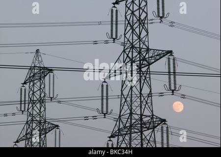 A full moon and electricity pylons in Leicestershire UK Stock Photo