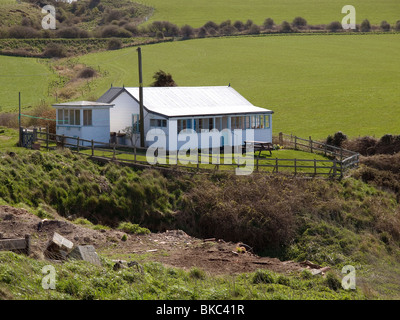 A holiday bungalow precariously perched on the cliff edge at Kettleness North Yorkshire Stock Photo