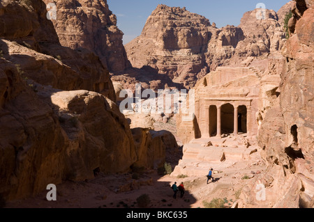 Tourists investigating the Garden Tomb in Petra, Jordan Stock Photo