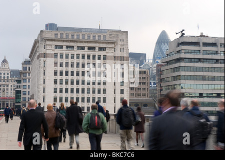 Commuters walking over London Bridge in the early morning rush hour, April 2010, UK Stock Photo
