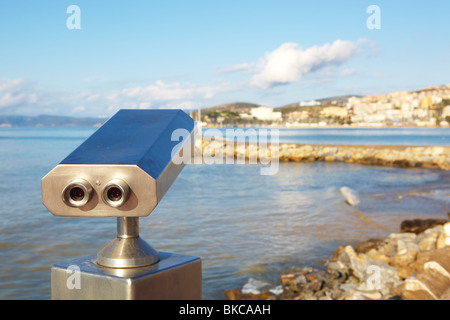 A metallic coin operated viewer for tourists to look at the Greek Islands over the Aegean from the Turkish harbor in Kusadasi on Stock Photo