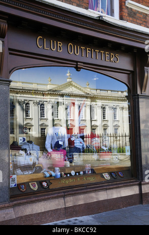 The Senate House reflected in the shop window of Ryder and Amies Club Outfitters, Cambridge, England, UK Stock Photo