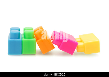 Colorful plastic building blocks arranged on white background Stock Photo
