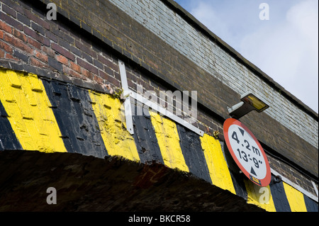 Road sign showing a height limit on a railway bridge in England. Stock Photo