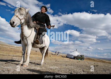 Nomad man in front of his ger (yurt or felt tent) near Tavan Bogd National Park, western Mongolia. Stock Photo