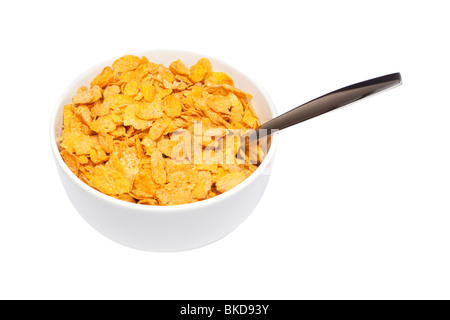 Cornflakes breakfast cereal in a white bowl with spoon Stock Photo