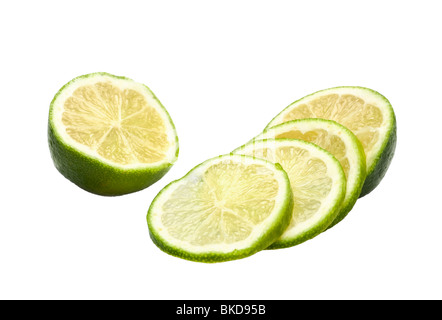 Limes whole and sliced on white Stock Photo