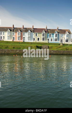 A row of colorful painted terraced houses overlooking Aberaeron harbour on a warm spring morning, Ceredigion, Wales UK Stock Photo