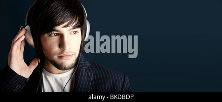 Young Man listening to music with headphones Stock Photo