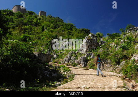 African American tourist hiking up to the Citadel, Milot, Cap Haitien, Haiti, Hispaniola, Greater Antilles, Caribbean, America Stock Photo