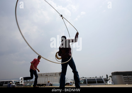 A boy tries to lasso his friend during an Escaramuza women's rodeo in Chalco on the outskirts of Mexico City Stock Photo