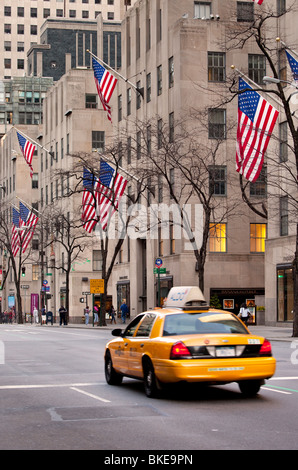 Lone Taxi Cab drives down 5th Avenue in Manhattan, New York City USA Stock Photo