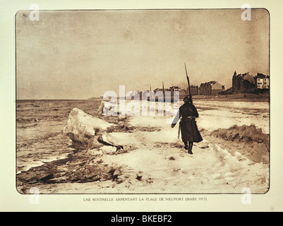 WWI soldier on patrol along beach in winter at Nieuwpoort / Nieuport, West Flanders during the First World War one, Belgium Stock Photo