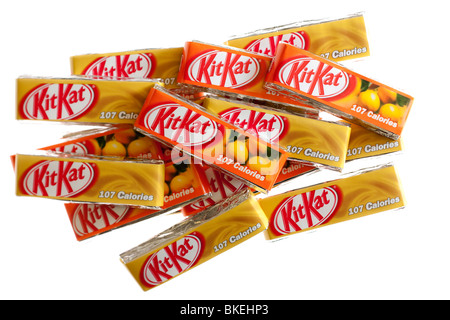 Pile of individual two finger packs of caramel and orange flavoured Nestle KitKat biscuits Stock Photo