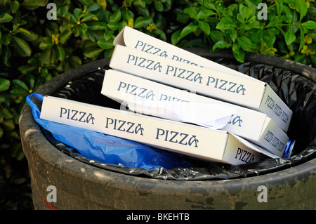 Pizza boxes in rubbish bin City of London England UK Stock Photo