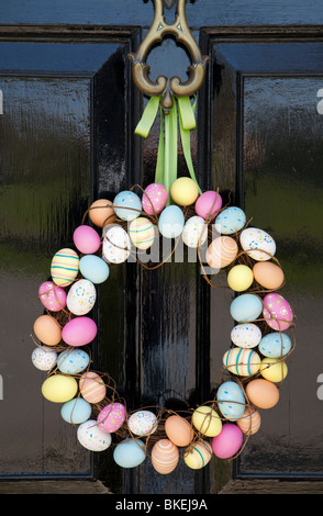 A wreath of coloured eggs hanging from a door knocker Stock Photo