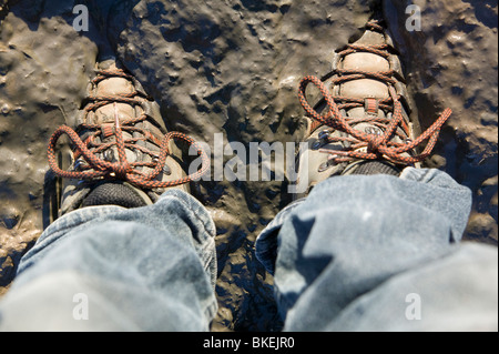 A walker in his boots stuck in mud Stock Photo