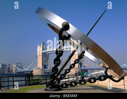 SUNDIAL Tower Bridge with sundial in foreground from St Katherine's Dock on a perfect blue sky sunny morning London UK Stock Photo