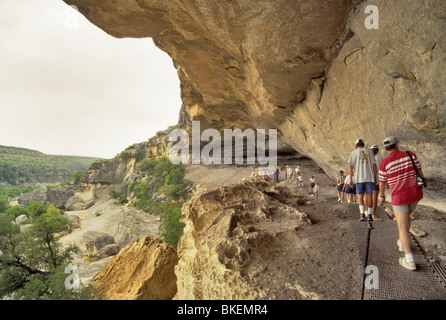 Tourists on guided tour to Fate Bell Shelter with its Indian pictographs at Seminole Canyon State Park, Texas, USA Stock Photo