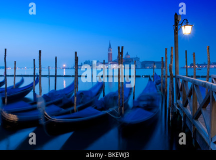 Gondola moorings at night before dawn beside Grand Canal at San Marco in Venice Italy Stock Photo