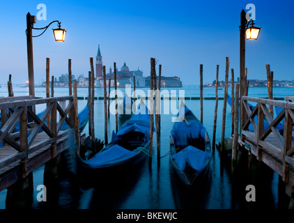 Gondola moorings at night before dawn beside Grand Canal at San Marco in Venice Italy Stock Photo