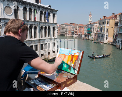Artist painting scene beside Grand Canal in Venice Stock Photo
