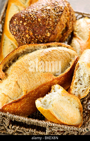 Various kinds of fresh baked bread in basket Stock Photo