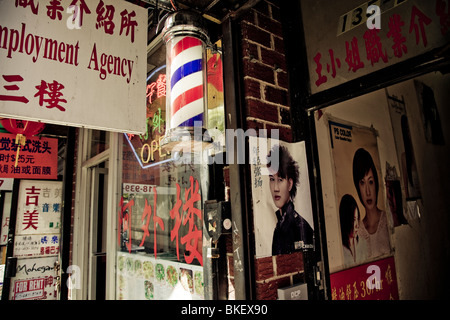 A barber shop and employment agency on 40th Avenue, Chinatown, Flushing, New York, USA Stock Photo