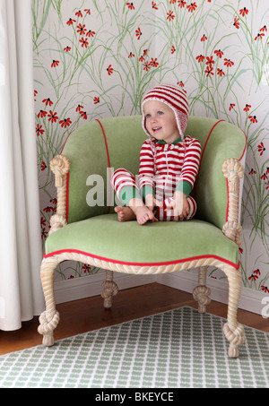 Little girl in red and white striped pajamas Stock Photo