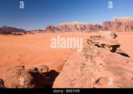 Approaching 4x4 vehicle in the distance in the desert of Wadi Rum, Jordan Stock Photo