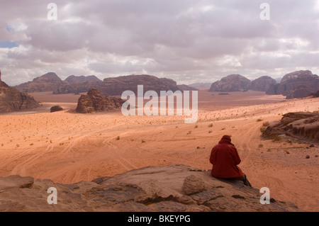 Female person looking over the red sands of the desert of Wadi Rum, Jordan Stock Photo